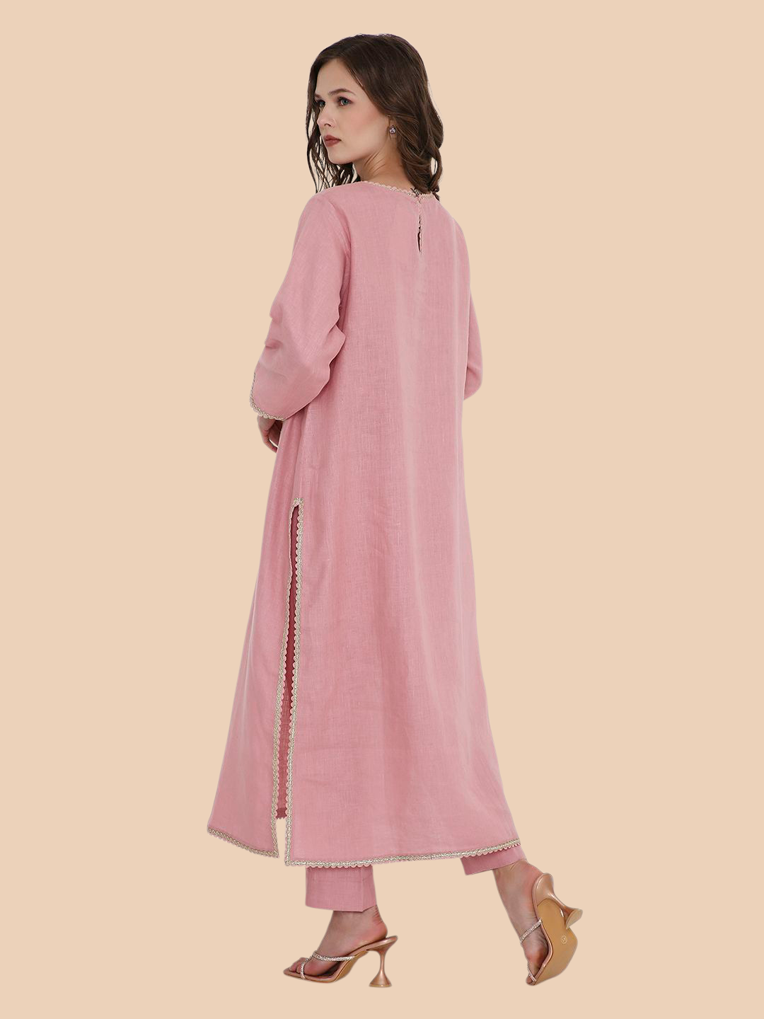 Woman wearing a pink traditional outfit on a beige background