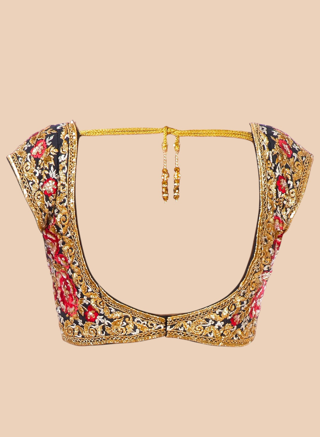 Decorative blouse with floral and gold embroidery on a beige background