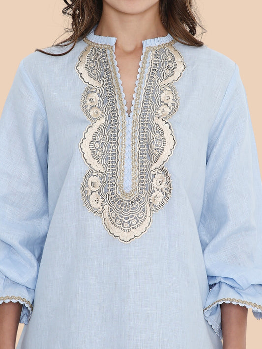 Light blue kurta with intricate lace detailing on a beige background