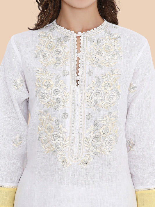 Close-up of ivory resham and zari embroidery on neckline and sleeve of kurta
