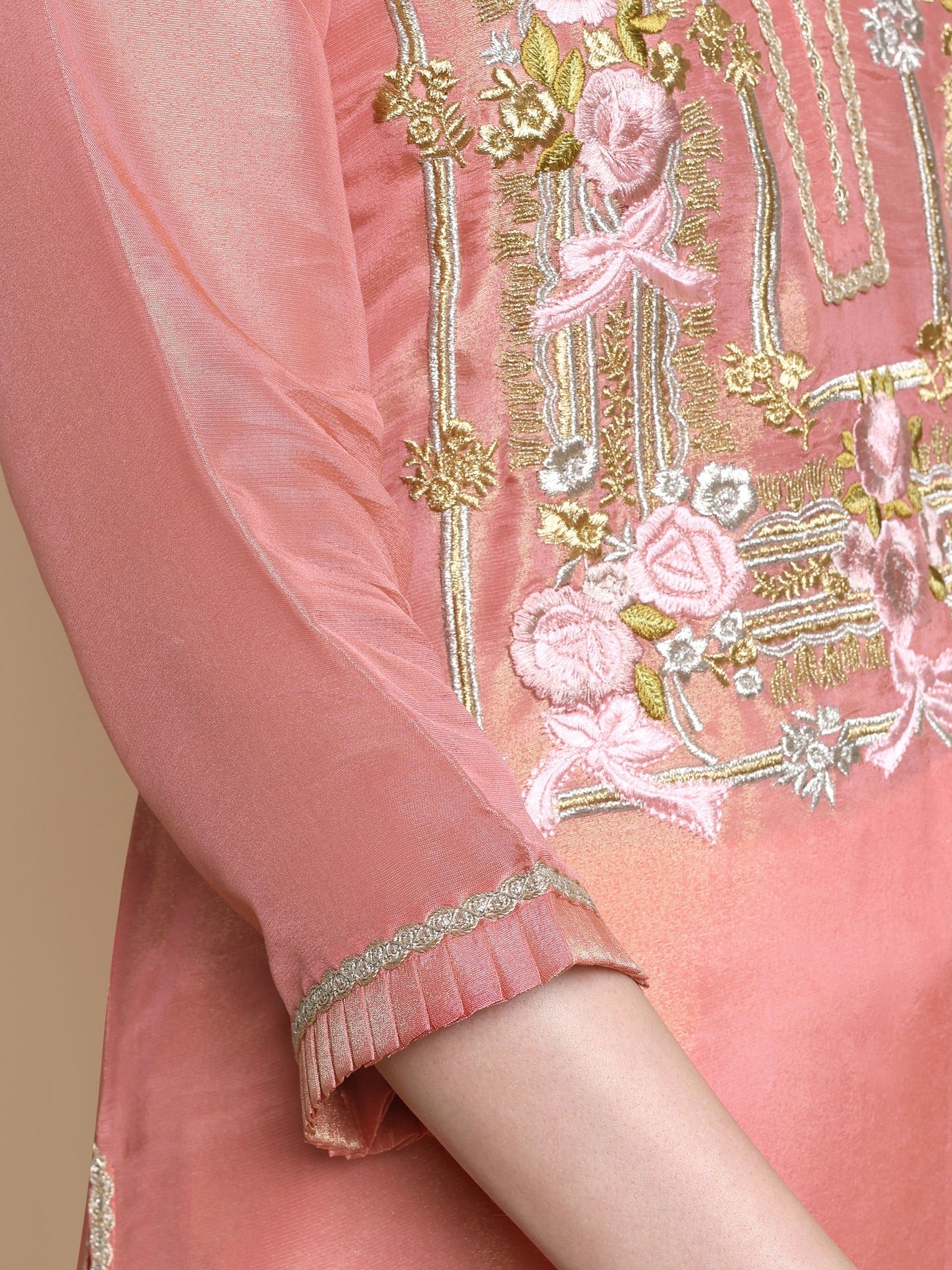 Close-up of floral Resham and zari embroidery on neckline of pink tissue kurta