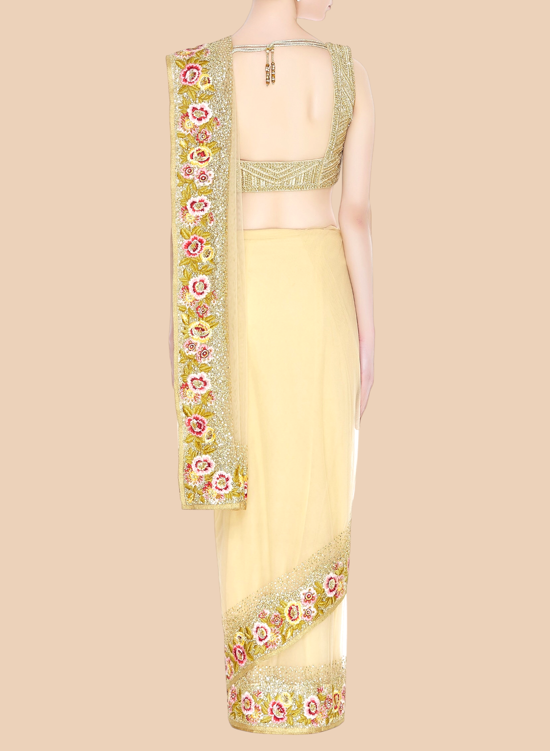 Light yellow saree with floral embroidery on a beige background
