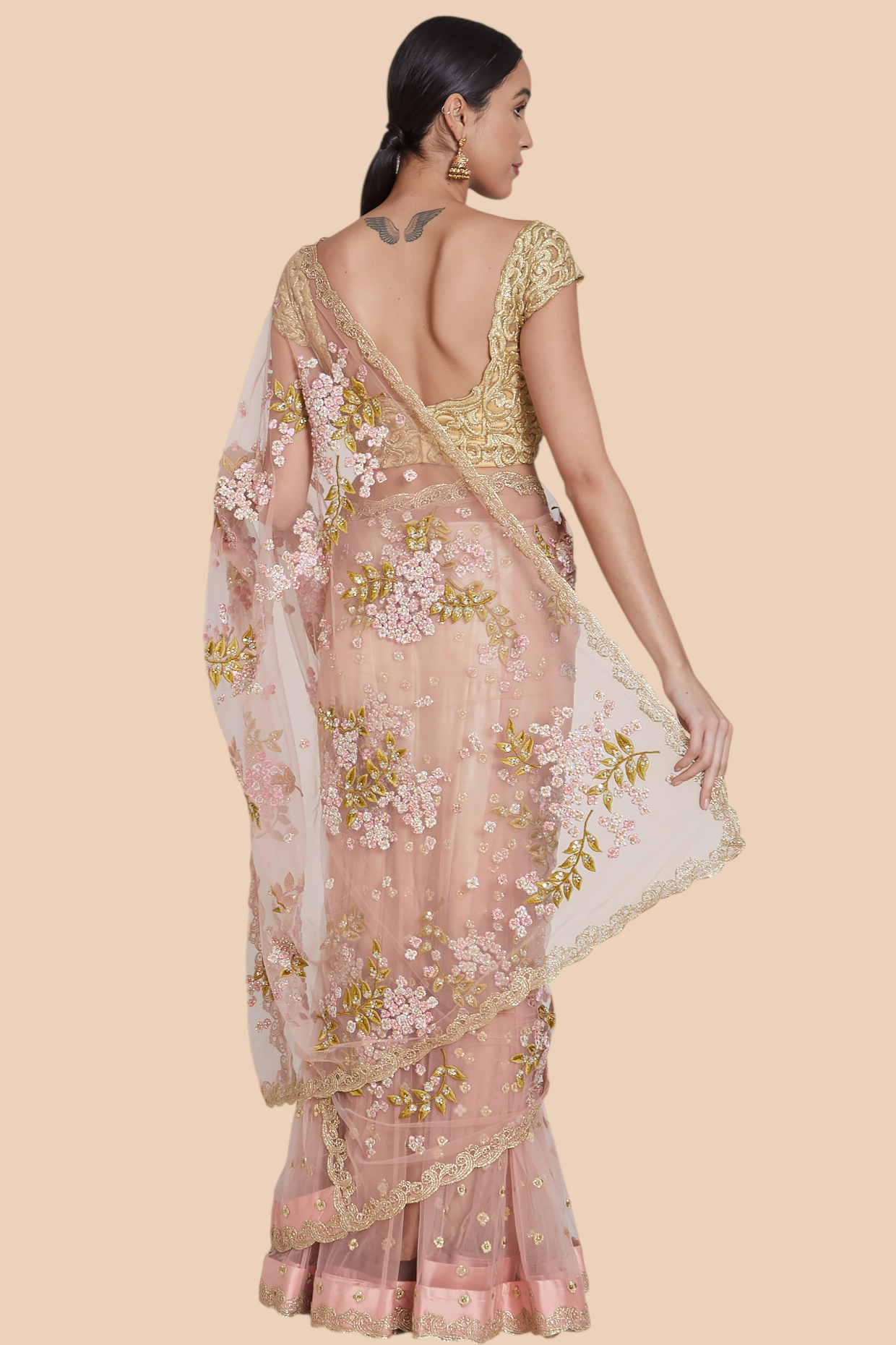 Back view of dull rose lehenga sari showcasing sequin kallis