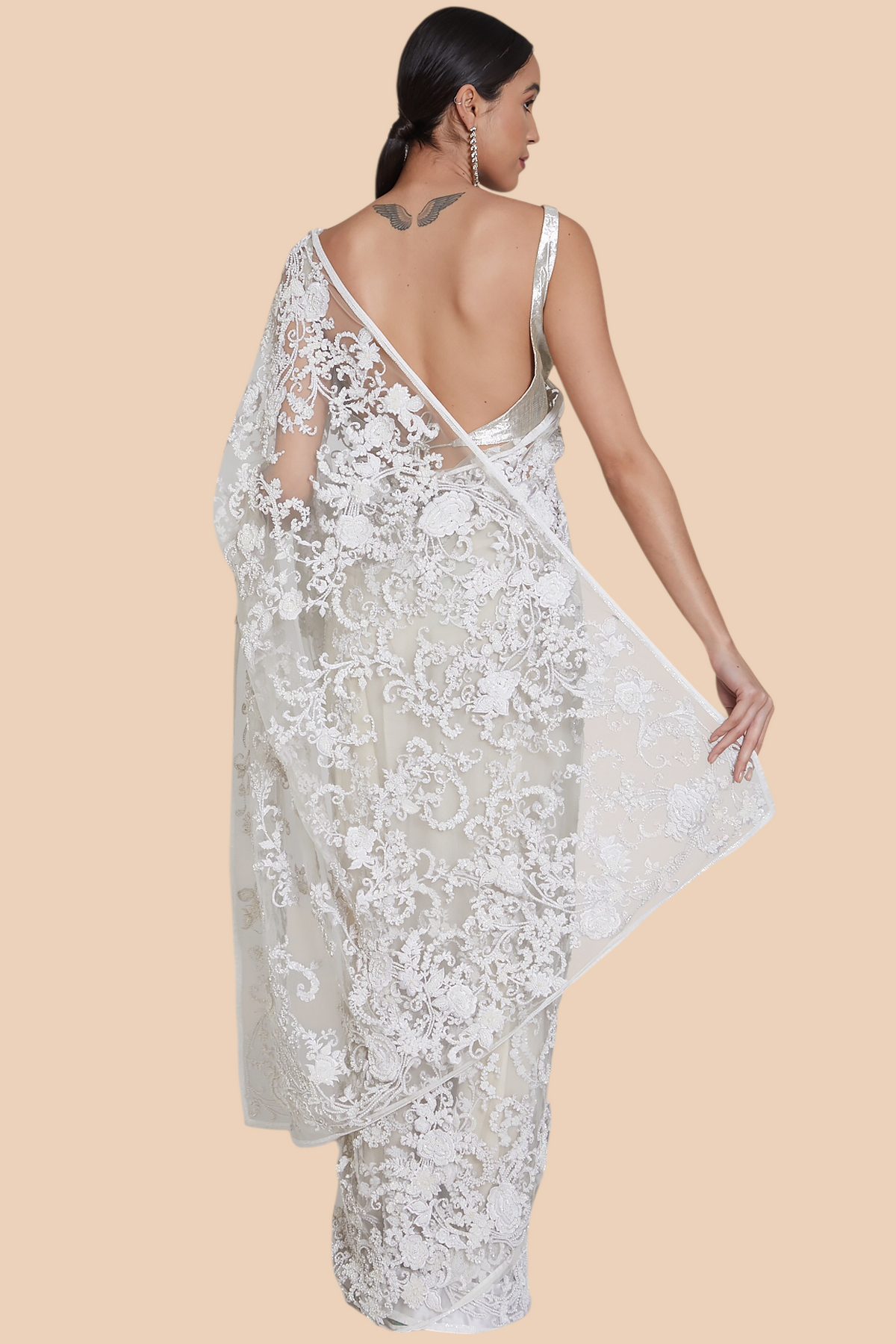 Back profile of white net sari with beadwork and sequin embroidery