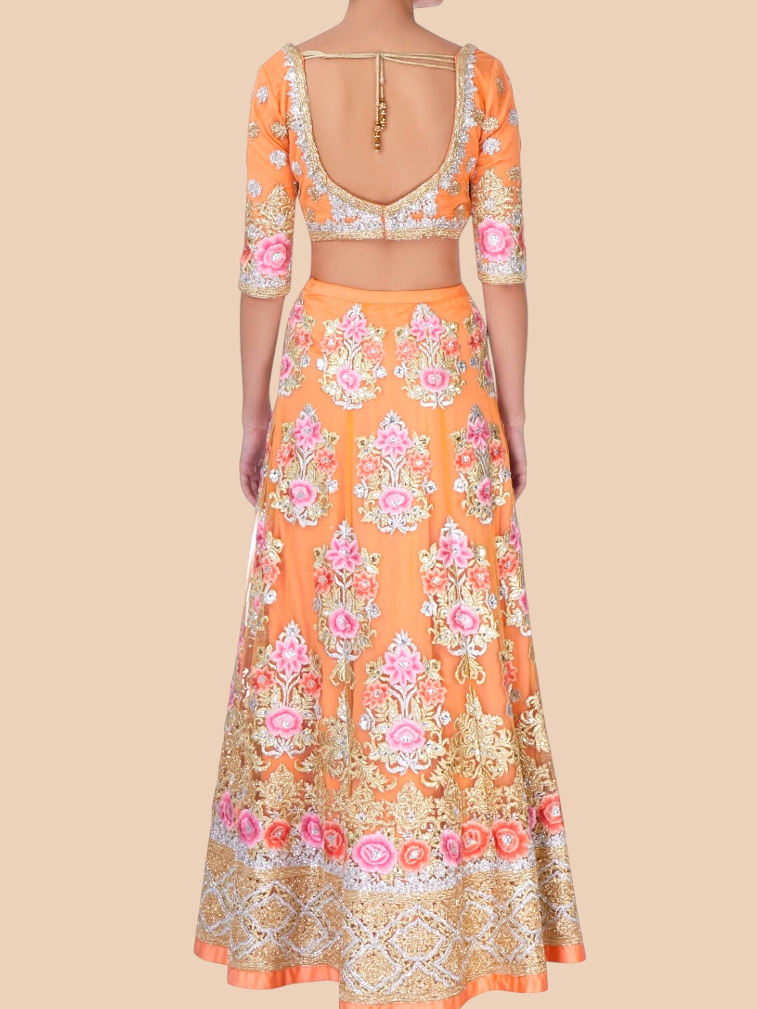 Orange floral dress with a matching top on a beige background