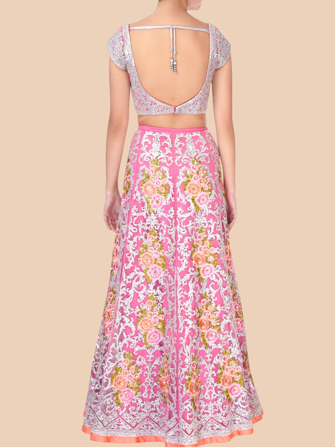 Back view of a person wearing a pink floral outfit on a beige background