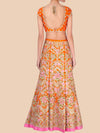 Orange and floral patterned outfit on a beige background