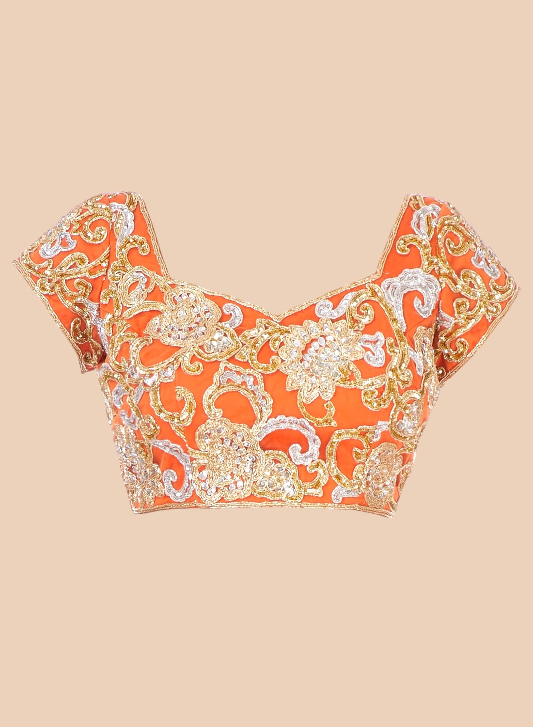 Orange floral patterned top on a beige background