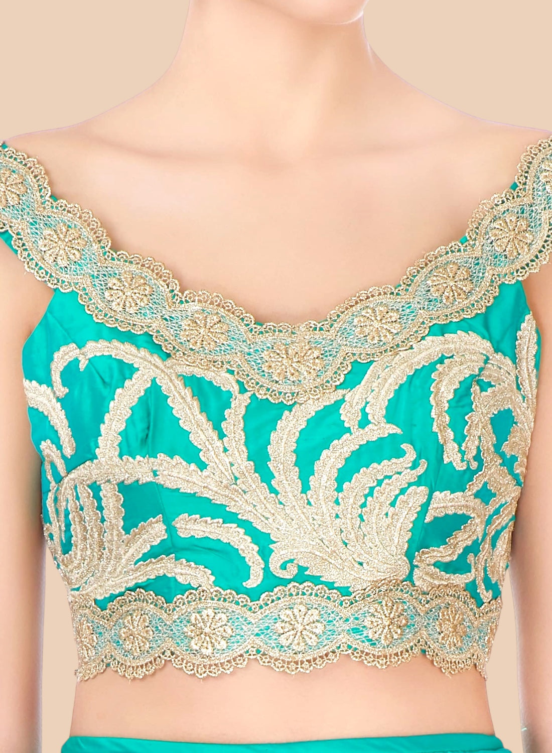 Teal top with gold embroidery on a beige background