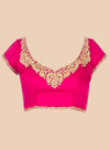 Pink blouse with gold embroidery on a beige background