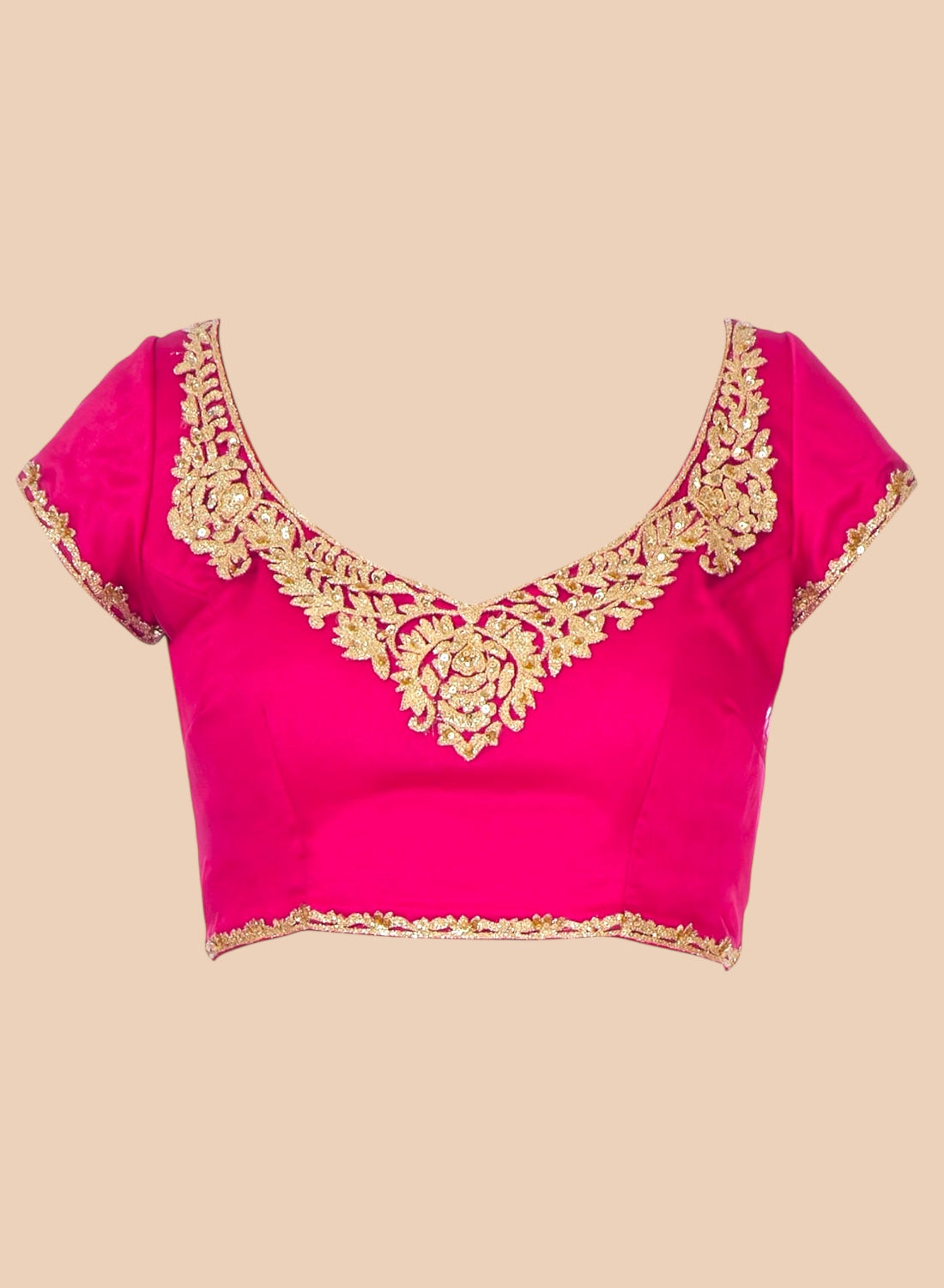 Pink blouse with gold embroidery on a beige background