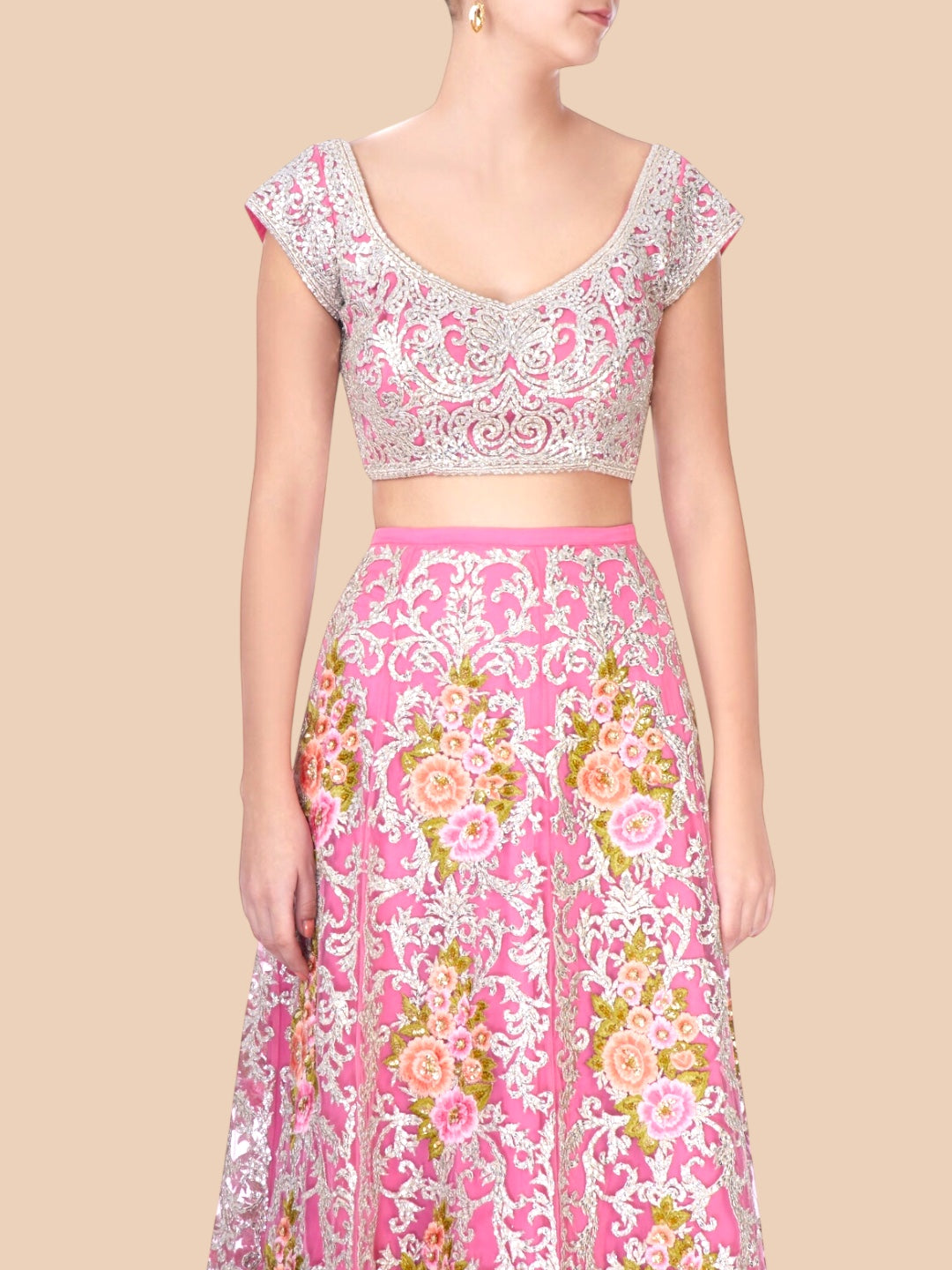 Woman wearing a pink floral dress with a beige background