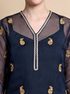 Woman wearing navy blue top with motif designs