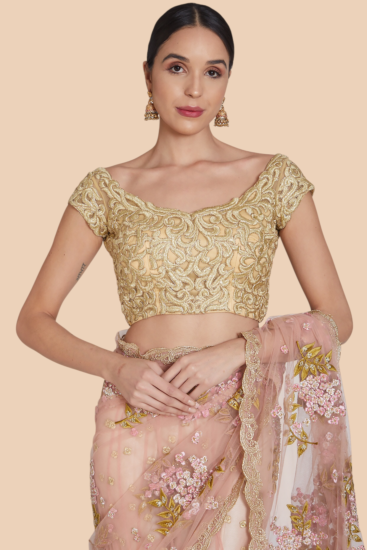 Close-up of matching embroidered blouse shown with lehenga sari