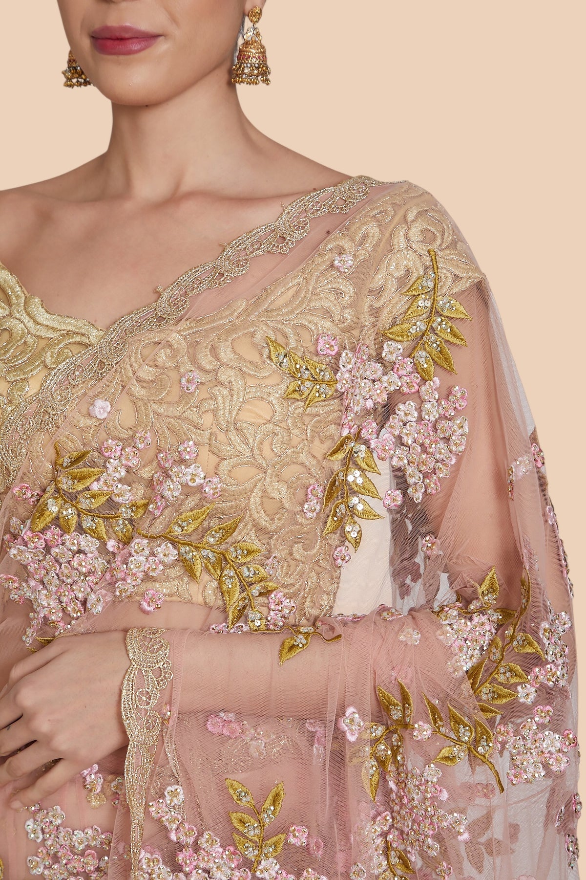 Close-up of berry bunch floral embroidery and sequins on dull rose net