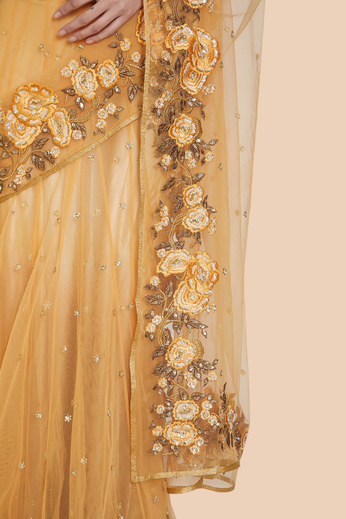 Close-up of antique gold and yellow floral embroidery with sequin buttis