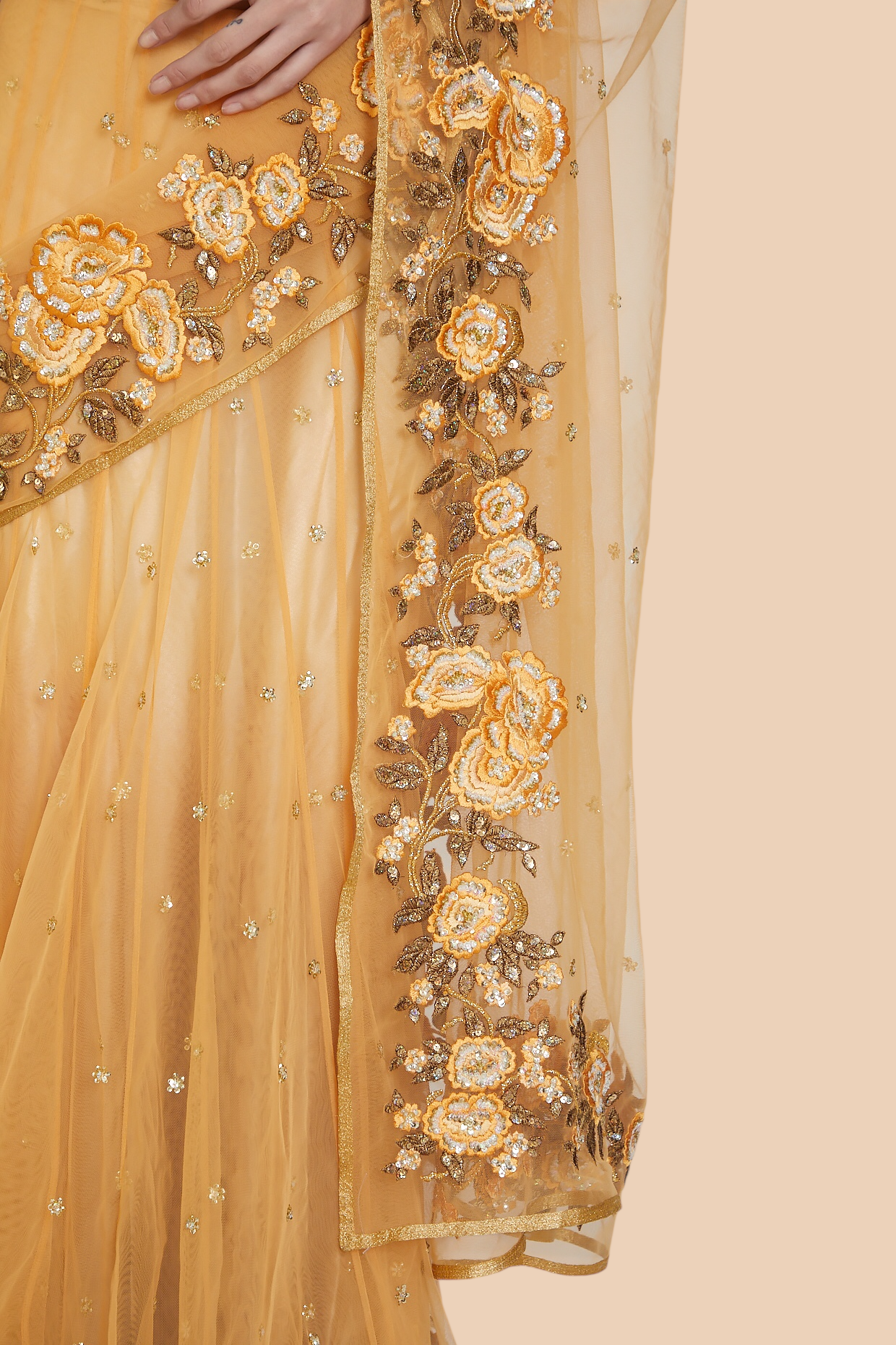 Close-up of antique gold and yellow floral embroidery with sequin buttis
