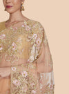 Close-up of gold resham floral border embroidery on peach sari
