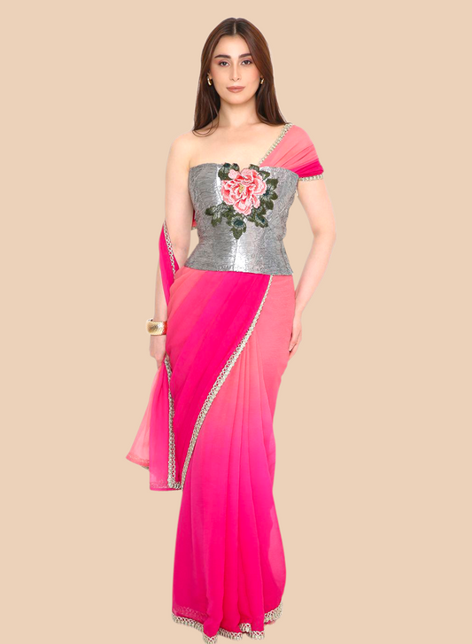 Woman wearing a pink corset with a silver blouse featuring floral embroidery on a beige background