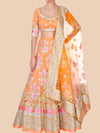 Orange and pink traditional outfit with floral patterns on a beige background