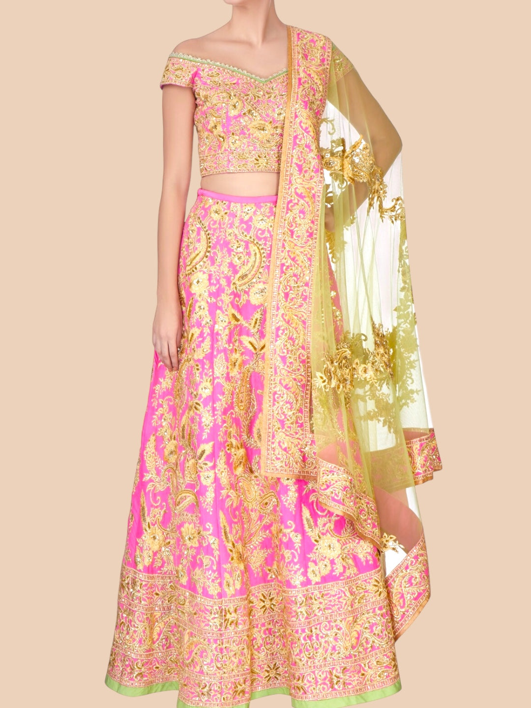 Traditional pink and gold embroidered outfit with a matching dupatta on a beige background
