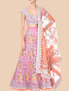 Traditional pink and white embroidered outfit with a matching dupatta on a beige background