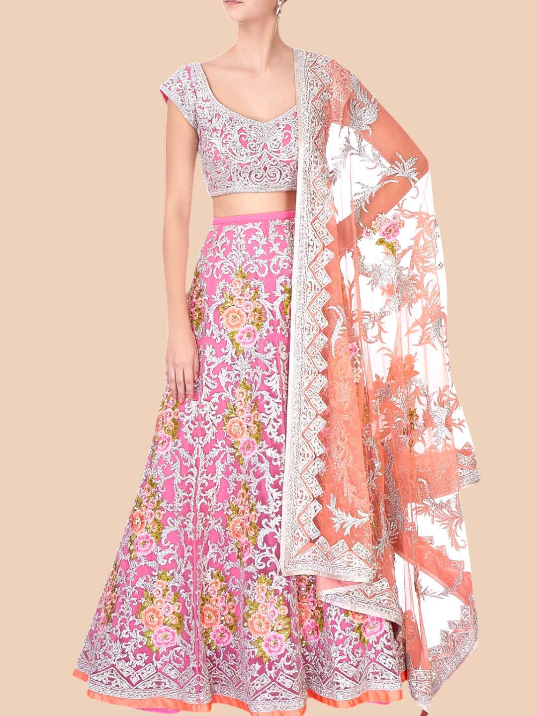 Traditional pink and white embroidered outfit with a matching dupatta on a beige background