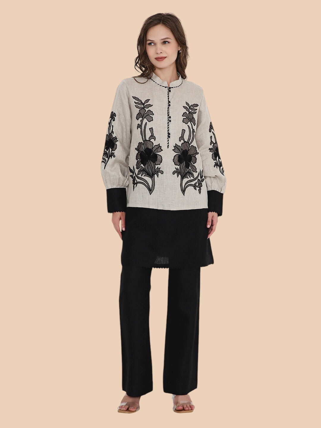 Woman wearing Beige Kurthi with Floral Designs and a Black Trouser