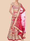 Red and gold traditional outfit with a matching dupatta on a beige background
