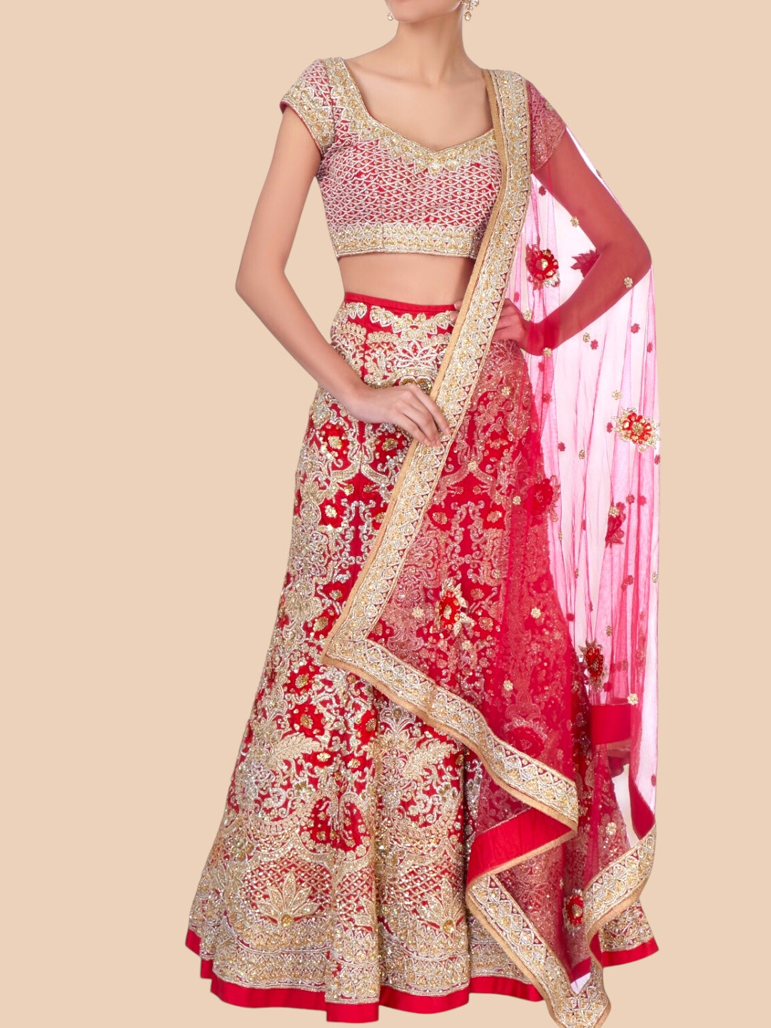 Red and gold traditional outfit with a matching dupatta on a beige background