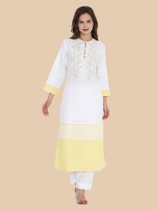 Front view of white linen kurta with ivory embroidery and yellow contrast hem, paired with white trousers