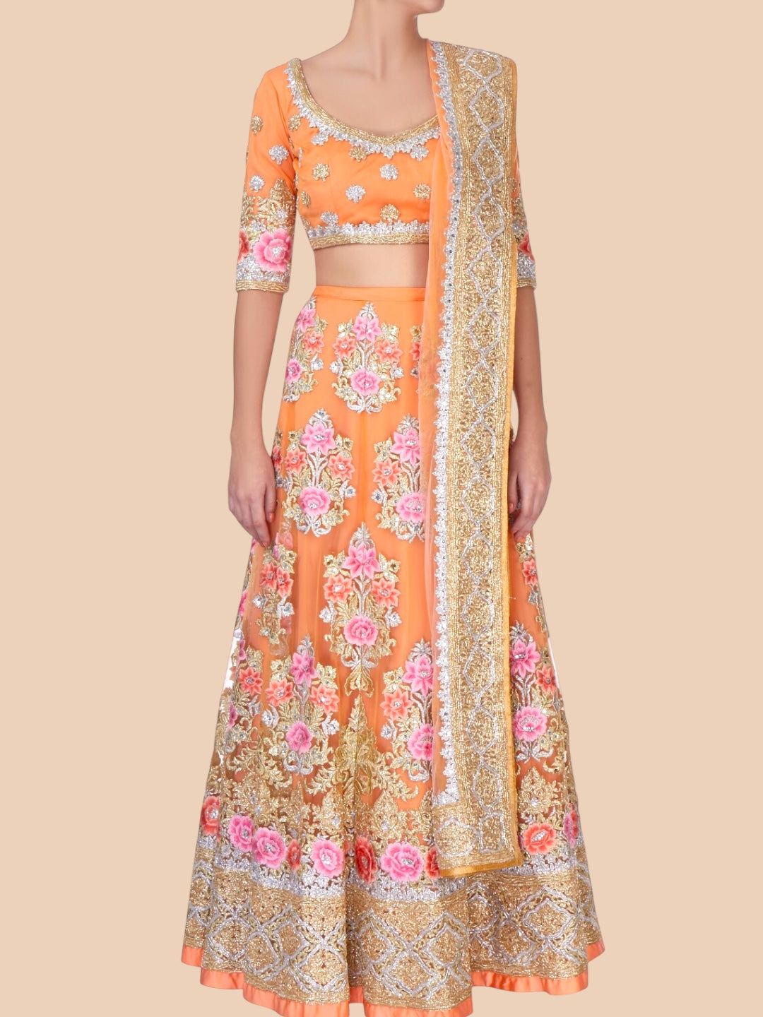 Orange and gold embroidered traditional outfit on a beige background