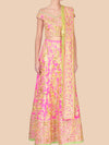Traditional pink and gold embroidered outfit on a beige background
