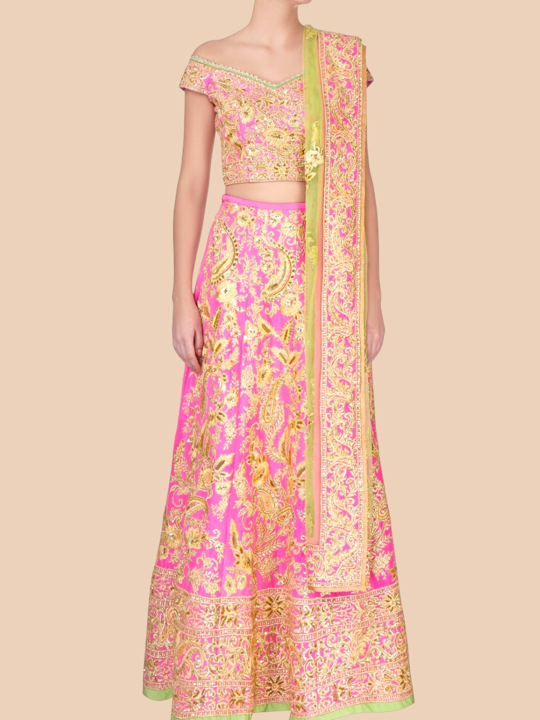 Traditional pink and gold embroidered outfit on a beige background