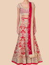 Red and gold embroidered traditional outfit on a beige background