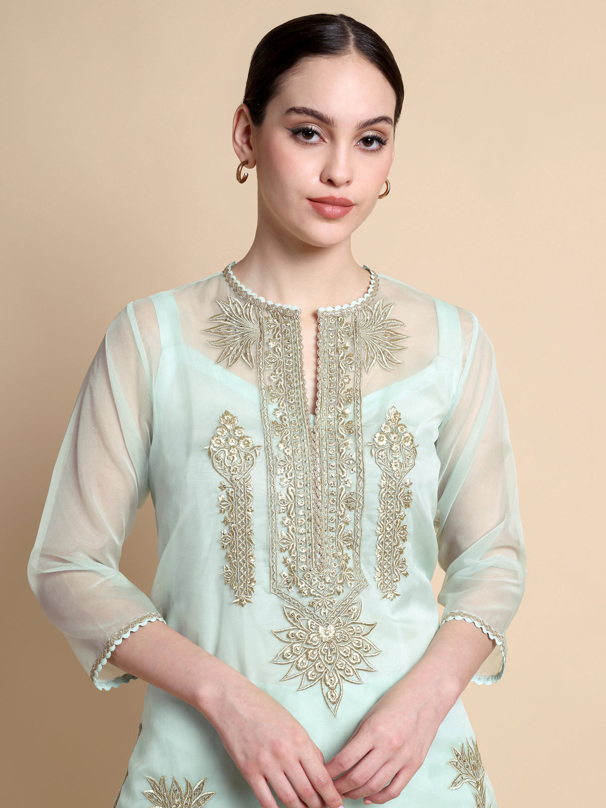 Light blue embroidered kurta worn by a model on a beige background