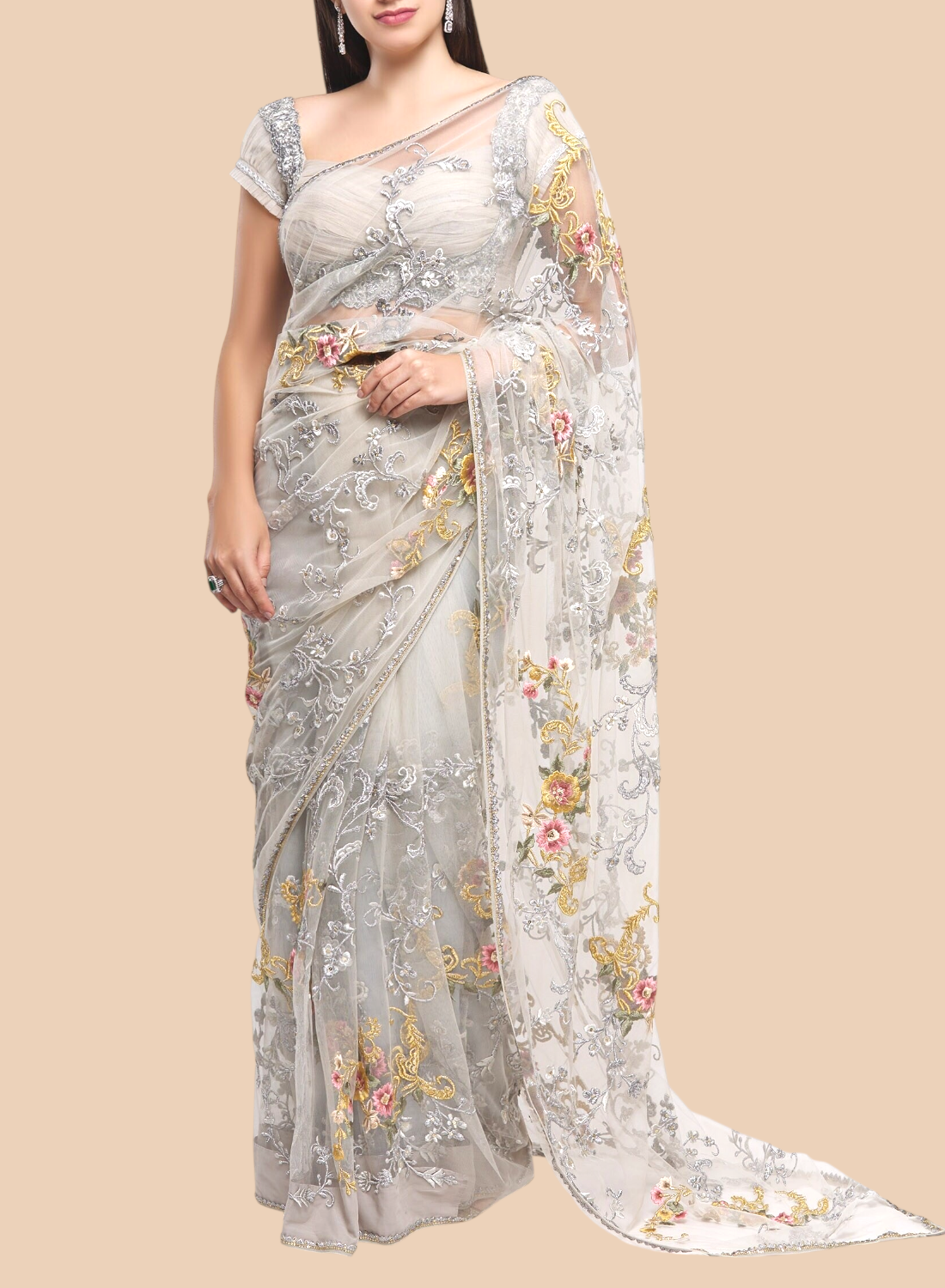 Woman wearing a floral saree with a plain background