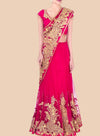 Red saree with gold embroidery on a beige background