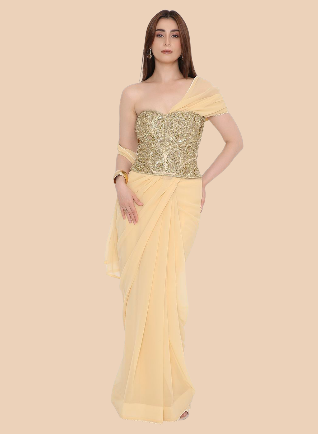 Woman wearing a yellow corset with a gold blouse on a beige background