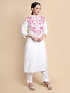 Woman wearing a white kurta with pink embroidery on a beige background