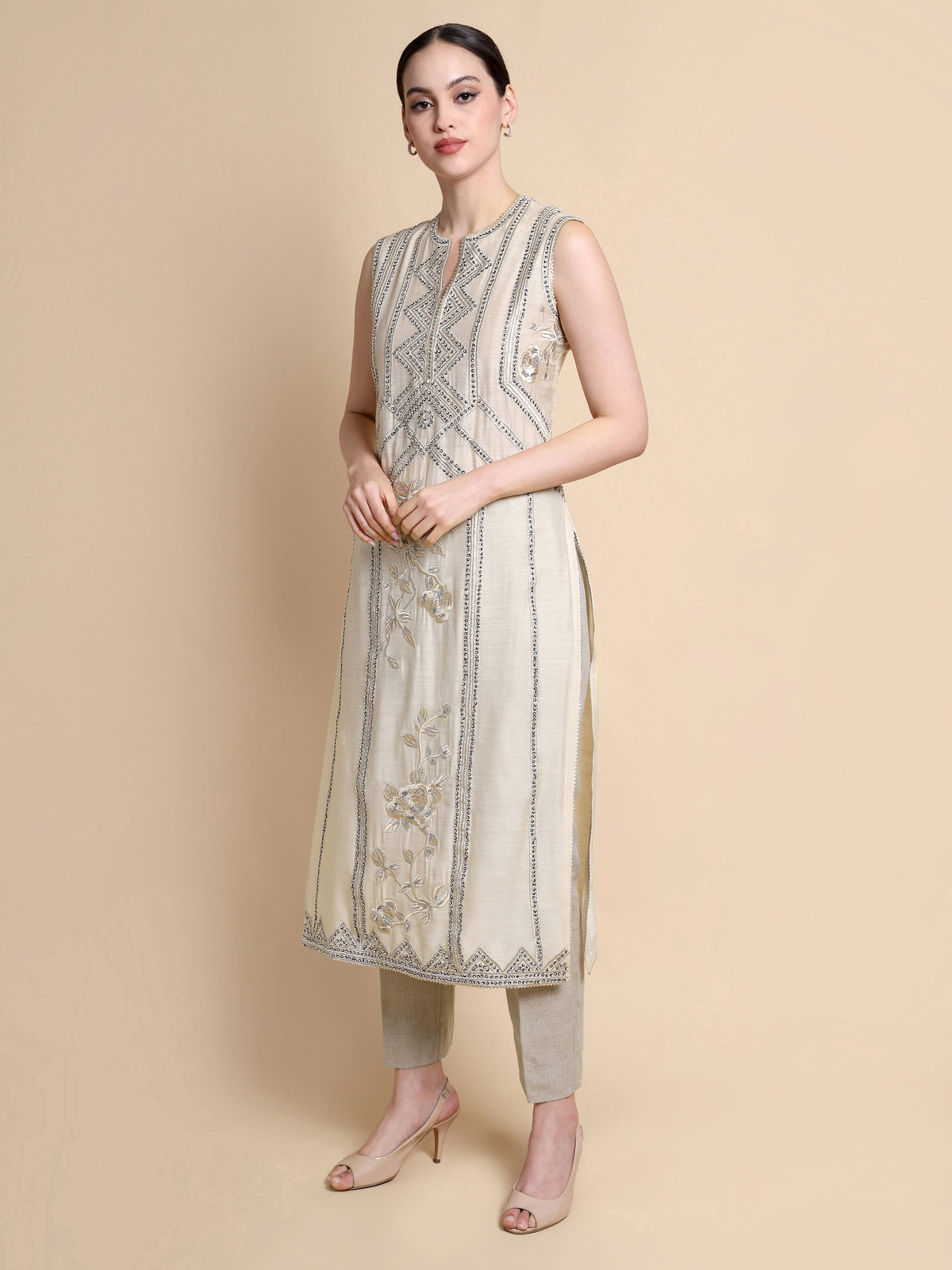 Woman wearing Offwhite Silk Sleeveles Top with Embroidery Work