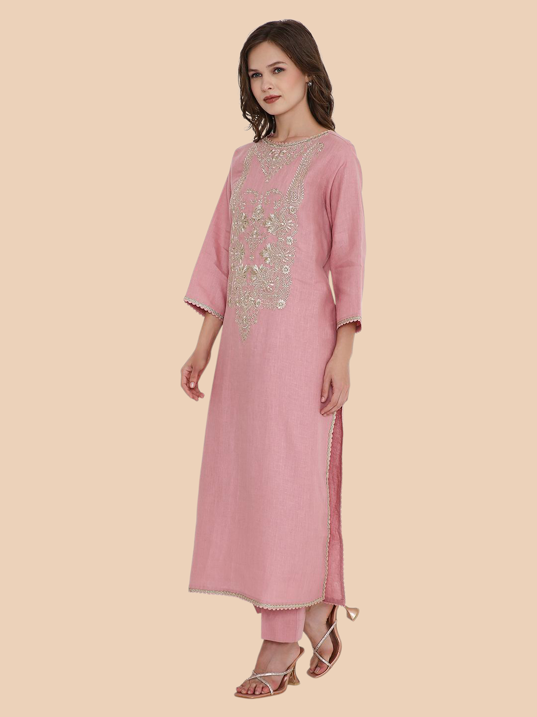 Pink kurta with silver embroidery on a beige background