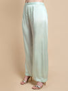 Light green wide-leg pants worn by a person on a beige background