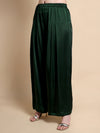 Dark green wide-leg pants worn by a person on a beige background