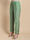 Green pants worn by a person on a beige background