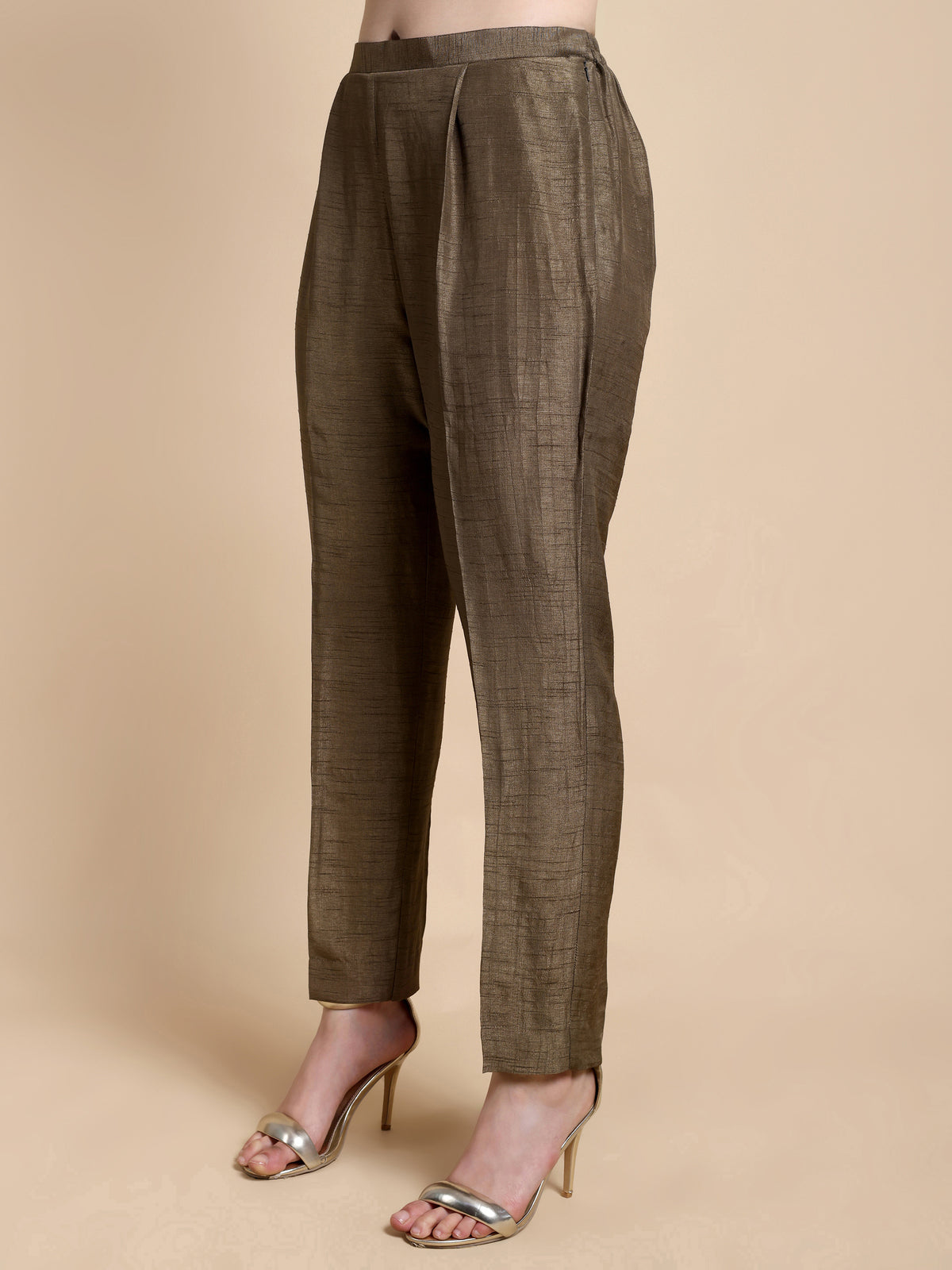 Brown checkered pants worn by a person on a beige background