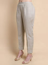 Light gray pants worn by a person on a beige background