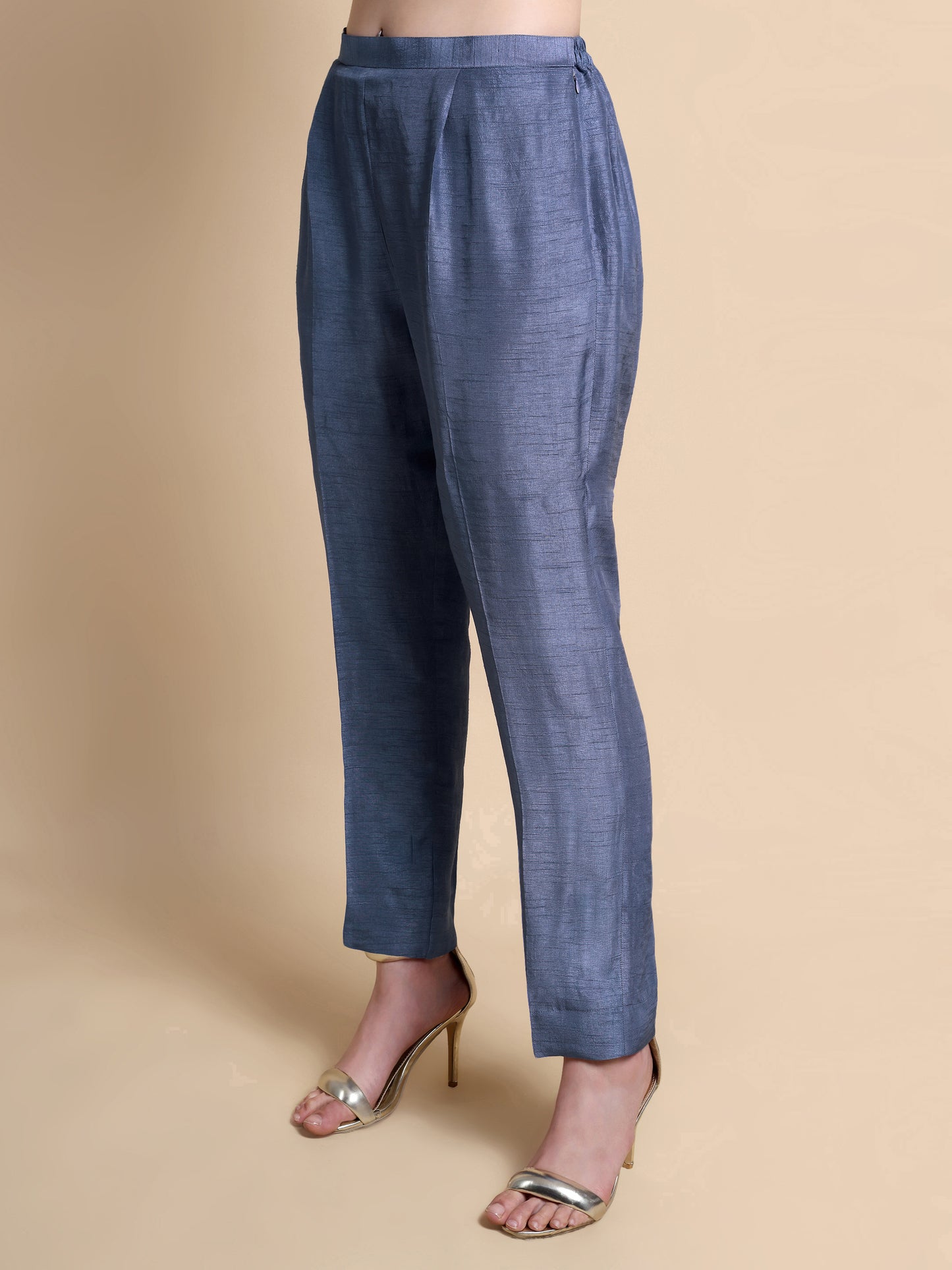 Blue pants worn by a person on a beige background