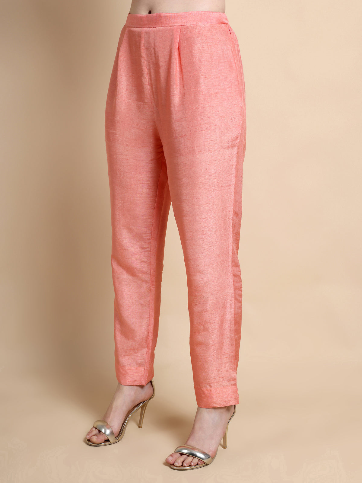 Pink pants worn by a person on a beige background