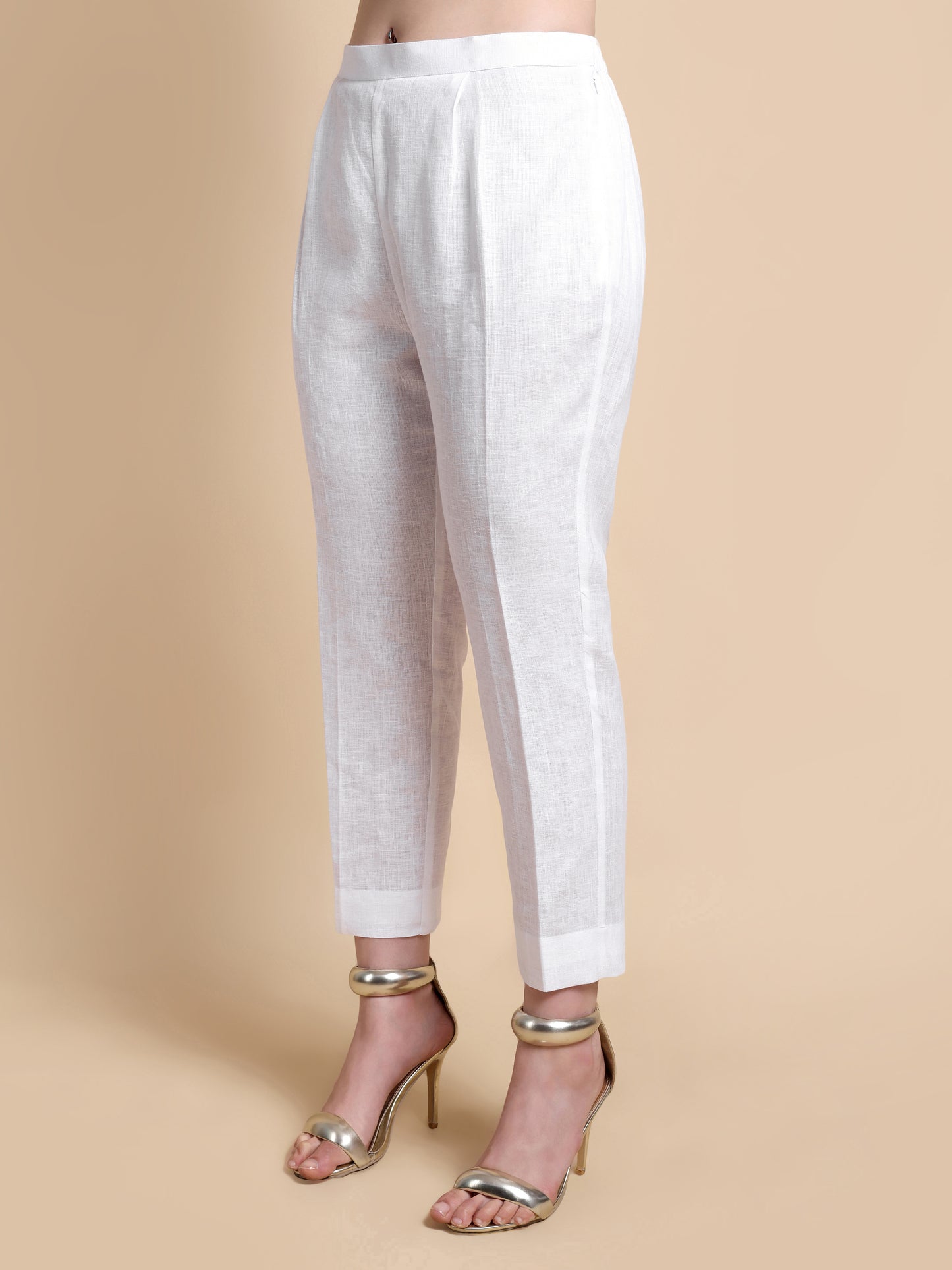 White pants worn by a person on a beige background